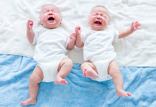 Chinese newborn twins crying stock photo