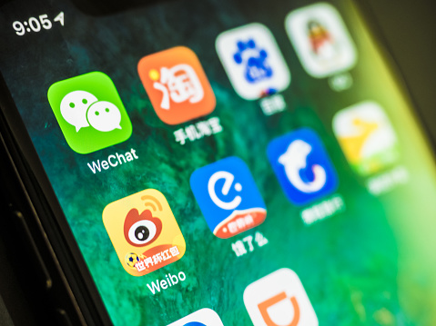 ChengDu China - July 10 2018: Apple iPhone X screen with Chinese Social Media and the rise of WeChat from Tencent with some other most famous in China 2018 mobile app on a smart phone.These companies are all in the market for more than ten billion dollars.