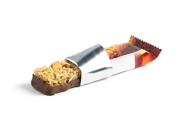 Chocolate and oat energy bar with wrapper opened stock photo