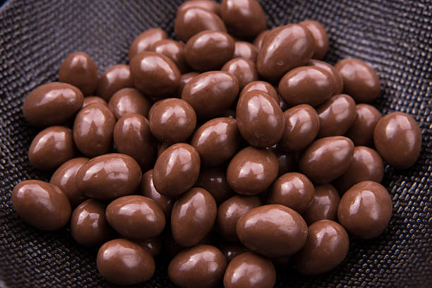 Chocolate ball candy on black background with nuts inside stock photo