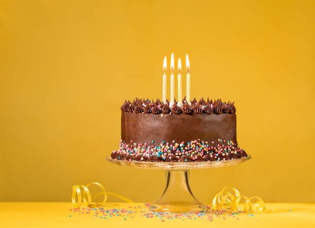 Chocolate Birthday Cake on Yellow stock photo