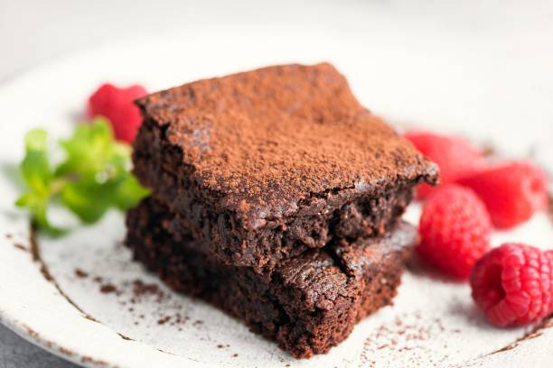 Chocolate brownies with cocoa powder stock photo