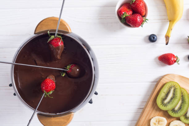 Chocolate fondue whith fruit and berries stock photo