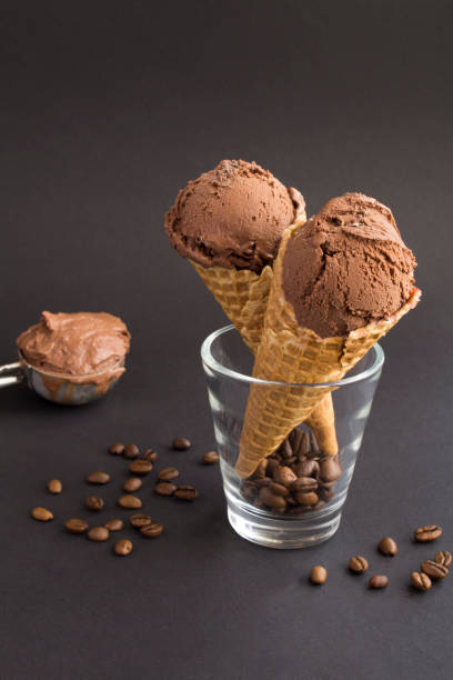 Chocolate ice cream in a waffle cone on the black background stock photo