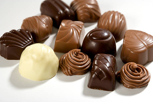 Chocolate Decorative Belgian chocolate on white background. In aRGB color for beautiful prints. chewy stock pictures, royalty-free photos & images