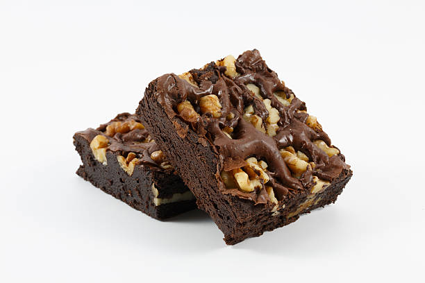chocolate walnut brownies on white background - brownie stockfoto's en -beelden