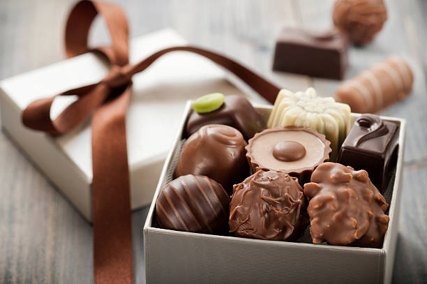 chocolates assorted chocolates confectionery in their gift box candy photos stock pictures, royalty-free photos & images