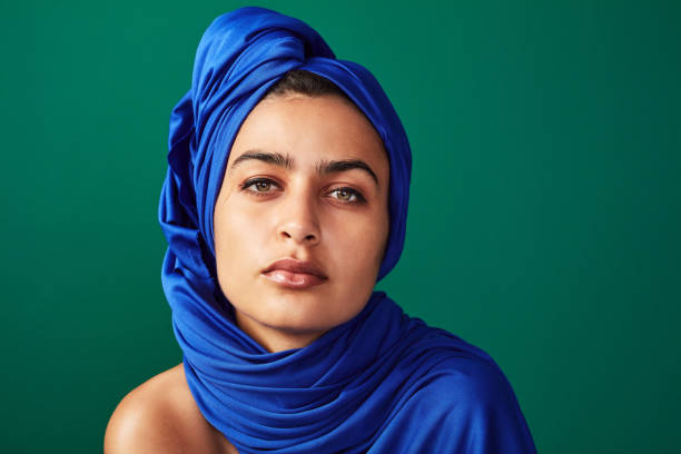I choose what I want to keep covered Shot of a beautiful young woman posing against a green background beautiful arab woman stock pictures, royalty-free photos & images