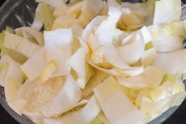 Chopped endive with apple pieces stock photo