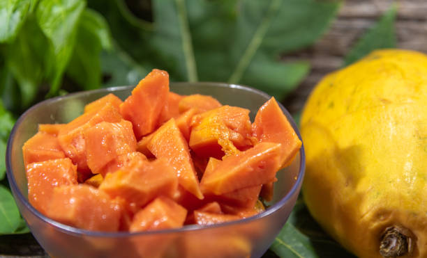 Chopped papaya fruit (Carica papaya L.) served in a bowl. Chopped papaya fruit (Carica papaya L.) served in a bowl. The fruit, called papaya has this name because it has the shape of a breast, which earned it the popular name of papaya. papaya smoothie stock pictures, royalty-free photos & images
