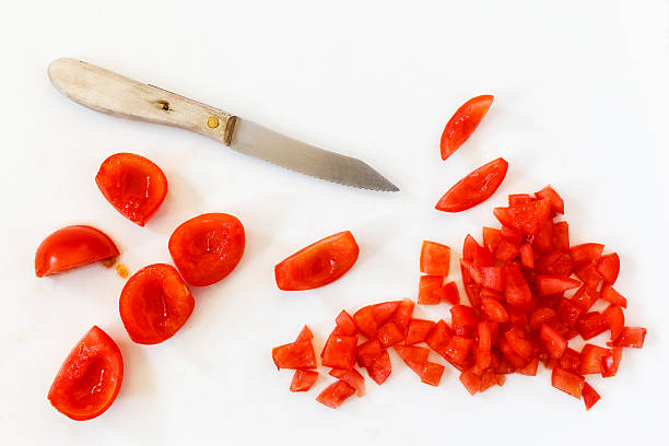 Chopped tomato, knife stock photo