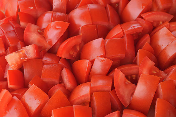 Chopped tomatoes pieces Chopped tomatoes pieces texture pattern chopped food stock pictures, royalty-free photos & images