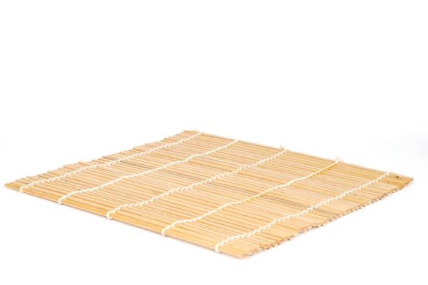 chopsticks on bamboo mat isolated on white background stock photo