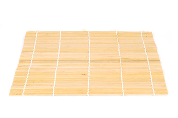 chopsticks on bamboo mat isolated on white background stock photo