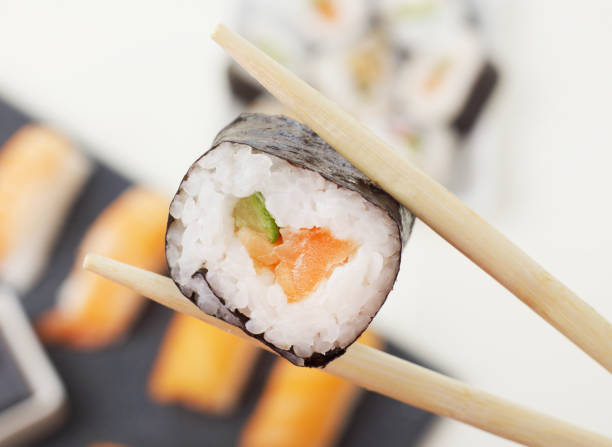 Chopsticks with sushi stock photo