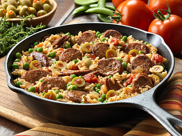 Chorizo and Spanish Rice Skillet Dinner Take on the traditional Paella. One pot meal of Chorizo and Spanish Rice made with tomatoes, onions, garlic green olives and peas, thyme and saffron. burwellphotography stock pictures, royalty-free photos & images