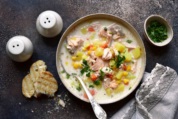 Chowder - thick potato soup with trout ( salmon ) and cream in a white bowl stock photo