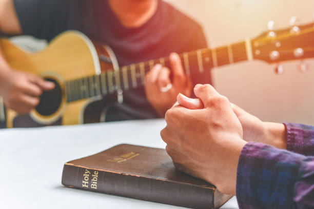 Christian family worship God in home, with a guitar and the Holy Bible. praise and worship concept Christian family worship God in home, with a guitar and the Holy Bible. praise and worship concept christian democratic union stock pictures, royalty-free photos & images