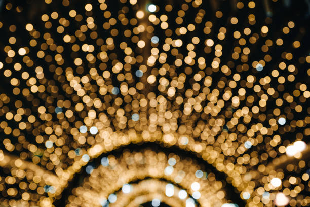 christmas background design with golden glowing bokeh ligts, festive abstract confetti. - christmas magic imagens e fotografias de stock