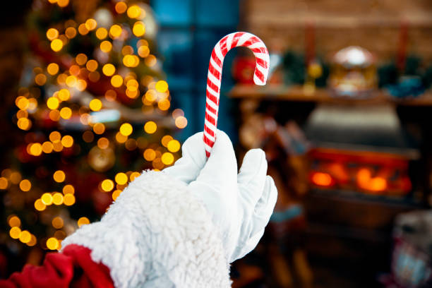 Christmas Candy cane lollipop in Santa Hand stock photo