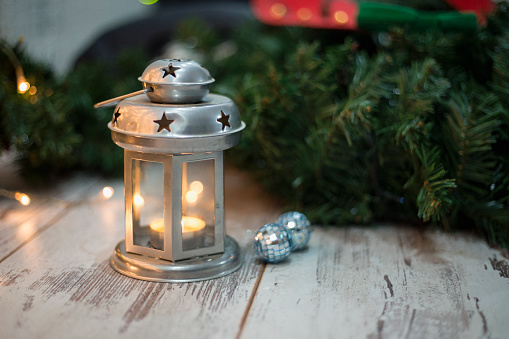Christmas Lantern on Wooden Floor with Pine Branches