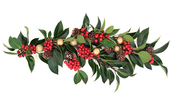 Christmas Decoration Christmas floral decoration of holly, baubles and pine cones over white background. centerpiece stock pictures, royalty-free photos & images