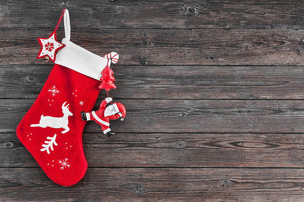 Christmas decoration stocking Christmas decoration stocking and toys hanging over rustic wooden background christmas stocking stock pictures, royalty-free photos & images