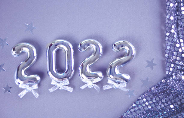 Christmas decoration with 2022 numbers in new pantone color very peri. Top view. stock photo