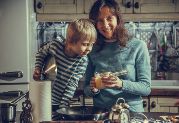 Christmas Eve. with mobile Christmas Eve. mom and son are drinking tea cooking photos stock pictures, royalty-free photos & images
