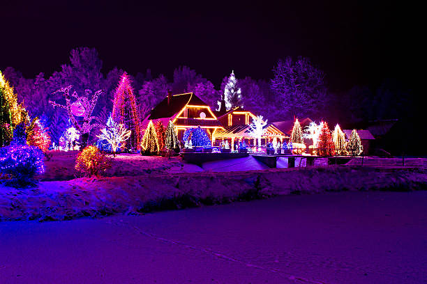 Christmas fantasy - park, forest & lodge in xmas lights Christmas fantasy - park, forest, pine tree & lodge in xmas lights christmas lights house stock pictures, royalty-free photos & images