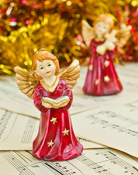 Christmas figurine of angels on a music sheet stock photo