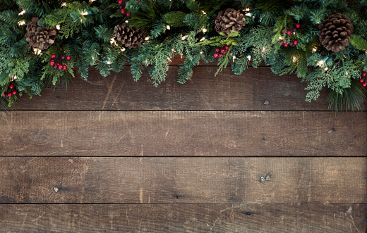 Christmas holiday garland on an old rustic wood background