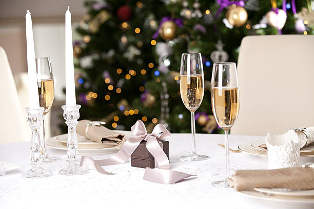 christmas gifts on the beautiful table with christmas tree - new years dinner table bildbanksfoton och bilder