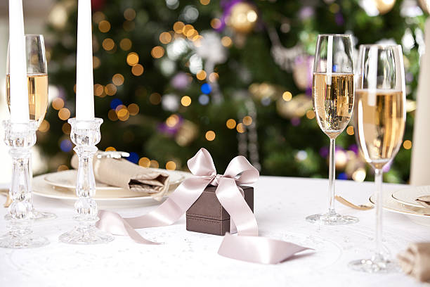 christmas gifts on the beautiful table with christmas tree - new years dinner table bildbanksfoton och bilder