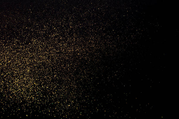 Christmas Gold glitter on black background. Holiday abstract texture stock photo
