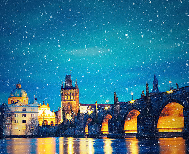 Christmas In Prague Charles Bridge in Prague on snowy Christmas evening. charles bridge stock pictures, royalty-free photos & images