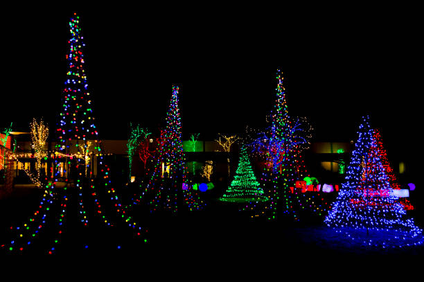 Christmas Light Garden This is a Christmas light display in Orem, Utah.  Different
colored trees surround the space and in the
background are light up blocks and balls that kids
can play with and push around.  I made the contrast
high on this picture so the lights stand out against
the black background of the night sky. christmas lights house stock pictures, royalty-free photos & images