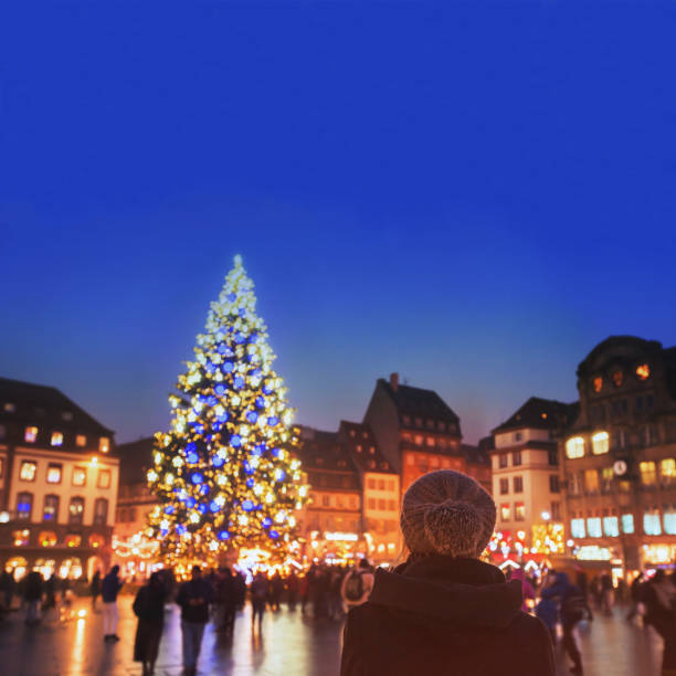 christmas market in Strasbourg, Europe christmas market in Europe, decorated xmas tree on the street of city, woman in warm hat enjoying cozy atmosphere strasbourg stock pictures, royalty-free photos & images