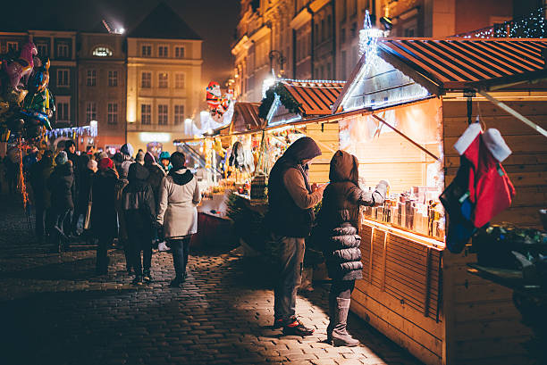 Christmas market Poznań, Poland – December 17, 2016: Young couple is buying souvernirs on the street.  poznan stock pictures, royalty-free photos & images
