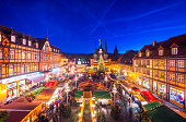 View over the town square with it´s beautiful medieval half-timbered houses and christmas market on the illuminated landmark town hall of Wernigerode.