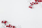 istock Christmas or winter composition. Snowflakes and red berries on gray background. Christmas, winter, new year concept. Flat lay, top view 1285648942
