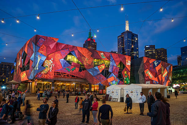Christmas projections at Federation Square, Melbourne Melbourne, Australia - December 10, 2016: A Christmas design is projected on the facade of a building at Federation Square. arts centre melbourne stock pictures, royalty-free photos & images