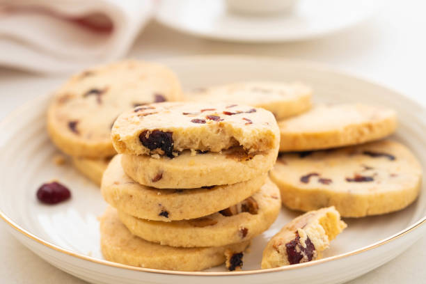 Christmas round cookies with walnuts and dried cranberries. Selective focus. Copy space. stock photo