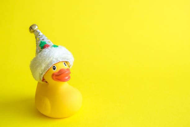 Christmas rubber duck toy for swimming on yellow background. stock photo