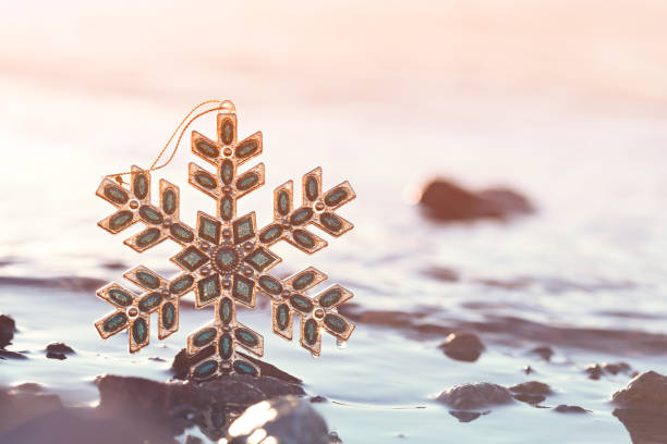 Christmas Snowflake At Sunset On The Beach stock photo