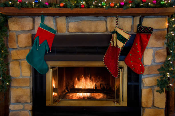 Christmas Three Stockings Hanging Over Fireplace stock photo