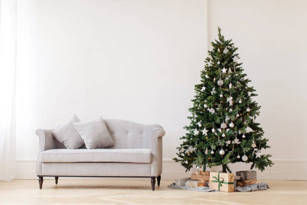 Christmas tree and gray couch stock photo