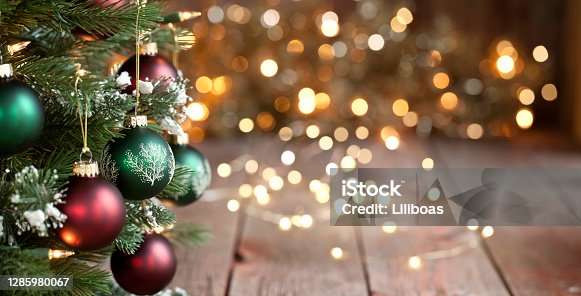 istock Christmas Tree, Red and Green Ornaments against a Defocused Lights Background 1285980067