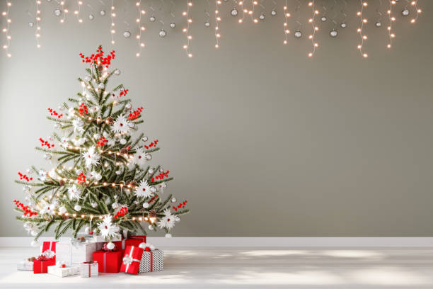 Christmas tree with red gifts in the room Christmas. stock photo