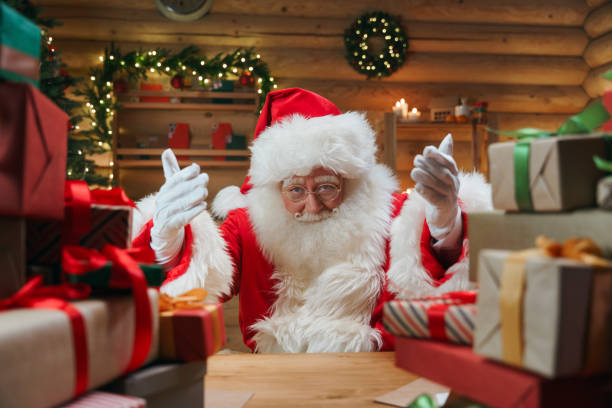 A Christmasy interior with Santa Claus calling us, by the gesture of his hands stock photo